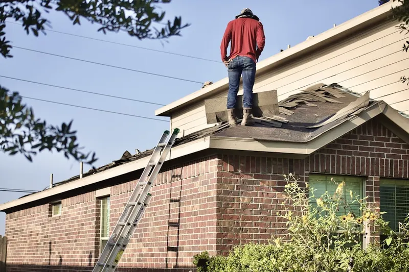 Professional roofer working on a residential roof in Selma